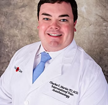 Dr Charles Martin in white lab coat and tie