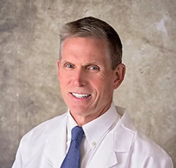 Dr Eric Pearson in white lab coat and tie